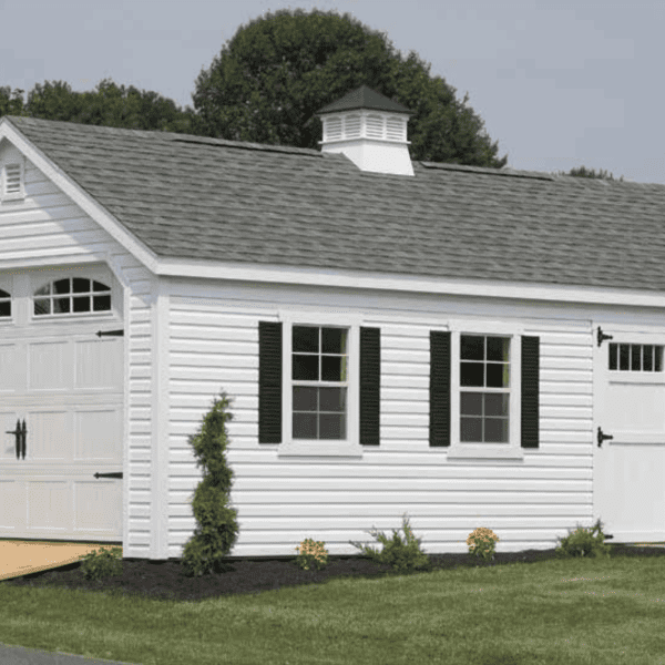 12 by 24 Colonial Garage with New England upgrade and optional carriage-style garage door, white vinyl siding, white trim, slate roof, black shutters.