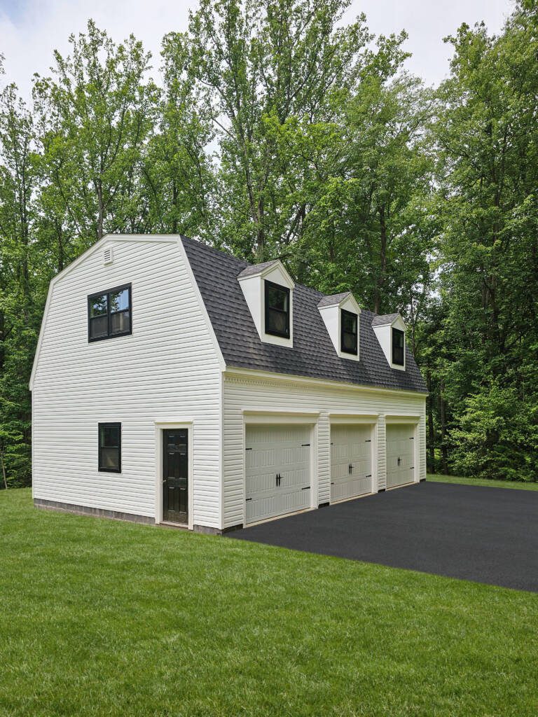 G66 | 24x36 3-car Garage with Loft and Cape Cod Dormers White vinyl siding, black windows, custom trim.